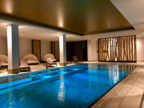 Sunny Suite 14 - elegantes Hotelapartment mit großem Pool-Wellnesbereich und seitlichem Meerblick in Börgerende-Rethwisch